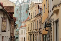 An illustrative photo of a narrow cobblestone street with Estonian buildings