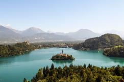 An illustrative photo of a lake with an island in the center.