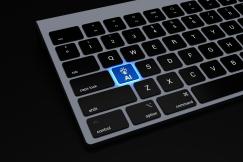 An illustrative photo of a keyboard on a black surface