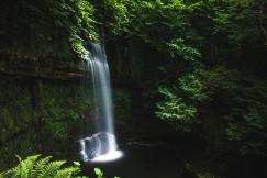 An illustrative photo of a scenic waterfall in a natural landscape