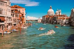 An illustrative photo of a canal with multiple boats.