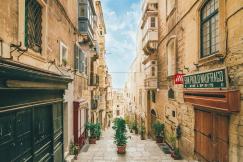An illustrative photo of narrow concrete street under blue sky
