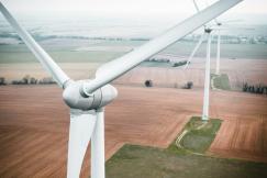 An illustrative photo of three windmills in the field
