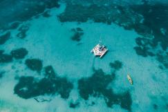 An illustrative photo of white boat on blue sea water