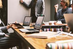 An illustrative photo of a group of individuals in a business meeting.