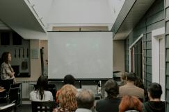 An illustrative photo of a group of people listening to the presentation