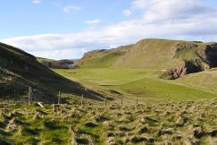 An illustrative photo of a field with hills 