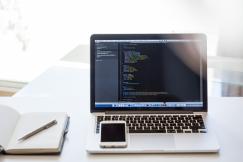 An illustrative photo of laptop with codes in its screen