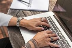 An illustrative photo of a person typing on laptop