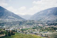 An illustrative photo of a landscape with agricultural fields in the foreground