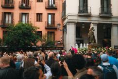 An illustrative photo of a crowd of people standing in front of a tall building