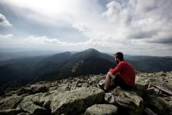 An illustrative photo of a man sitting on large rocks