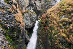 An illustrative photo of a waterfall in the middle of a canyon