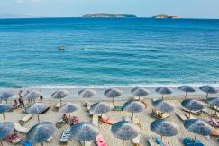 An illustrative photo of a beach lounge on seashore.