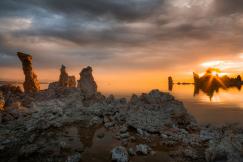 An illustrative photo of rock formations near sea during sunset