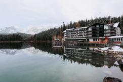 An illustrative photo of a lake with a hotel in the background.