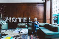 An illustrative photo of a woman sitting on a sofa