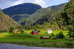 An illustrative photo of a lush green valley framed by majestic mountains in the distance