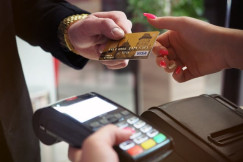 An illustrative photo of a sleek black payment terminal