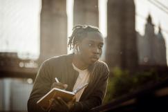 An illustrative photo of a person outdoors, reading a book