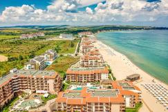 An illustrative photo of a coastal resort area with multiple buildings