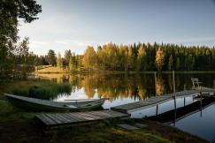 An illustrative photo of a white boat on lake dock.