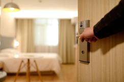 An illustrative photo of person holding on door lever inside room
