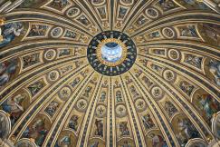 An illustrative photo of a majestic dome ceiling with fresco paintings in a Catholic cathedral