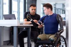 An illustrative photo of an engineer fitting prosthetic arm