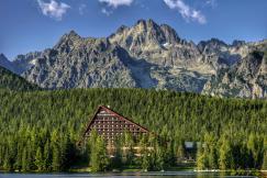 An illustrative photo of a building near a rocky mountain.