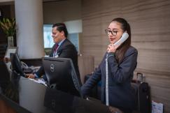 An illustrative photo of a hotel receptionist on a phone call