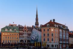 An illustrative photo of a cityscape at dusk with historical buildings.