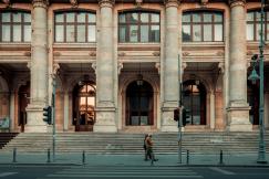 An illustrative photo of a person walking pass building