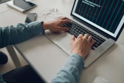 An illustrative photo of a man working on a laptop