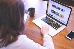 An illustrative photo of a woman working on a laptop