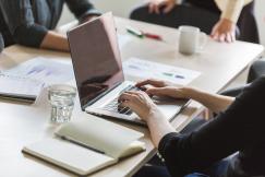 An illustrative photo of a woman working on the laptop