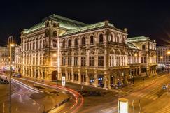 An illustrative photo of Vienna state opera at night.