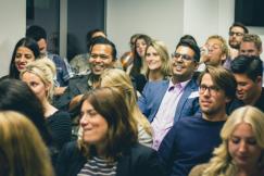 An illustrative photo of a group of people on a conference