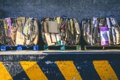 An illustrative photo of a stack of flattened cardboard boxes.