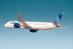 An illustrative photo of a white and blue passenger plane in flight