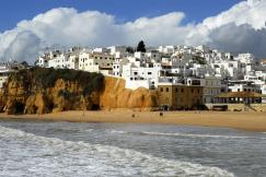An illustrative photo of a coastal scene with a sandy beach in the foreground.