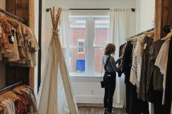 An illustrative photo of a woman selecting clothes in a shop