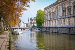 An illustrative photo of a canal with boats in the old town in Belgium
