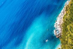An illustrative photo of a coastline where the ocean meets a rocky shore