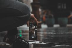 An illustrative photo of a person holding a smartphone with the camera app open.