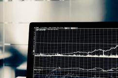 An illustrative photo of a close-up view of a computer monitor displaying a graph with multiple lines