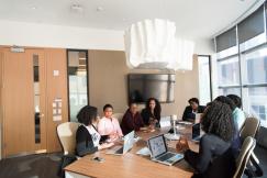 An illustrative photo of a group of people engaging in a meeting inside a well-lit room
