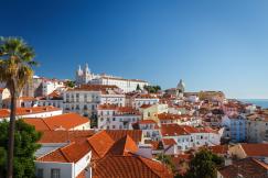 An illustrative photo of many white buildings with brown roofs
