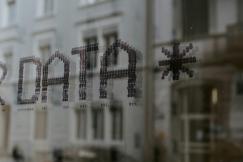 An illustrative photo of the word “DATA” written on a glass.