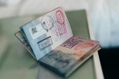 An illustrative photo of a passport with stamps on the table